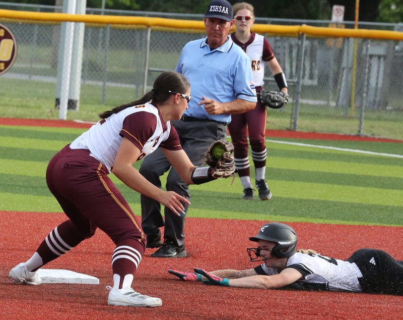 Frontenac's Paige Unruh slides underneath the tag of her fellow shortstop, Girard senior Maddie Coester, during their game Monday. BROCK SISNEY / THE MORNING SUN