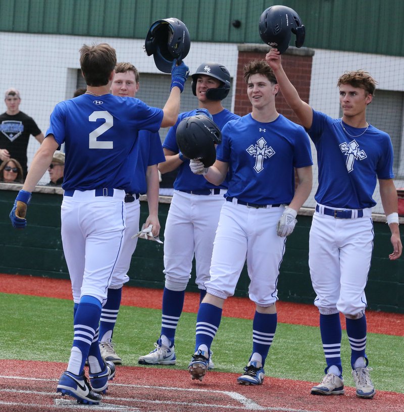 Colgan senior Brady Crossland taps helmets with classmates Brock Radell and Brady Badart as he crosses home plate during his game-ending three-run home run Thursday against Marmaton Valley. BROCK SISNEY / THE MORNING SUN