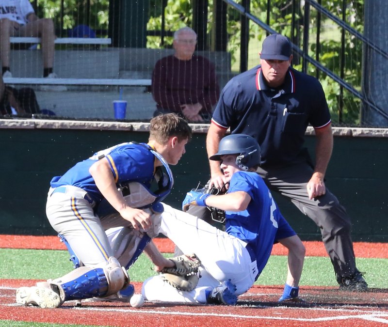 Brady Crossland slides in under the tag at home plate