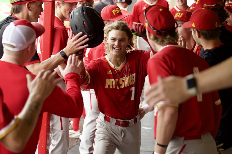 Baseball team high fives player