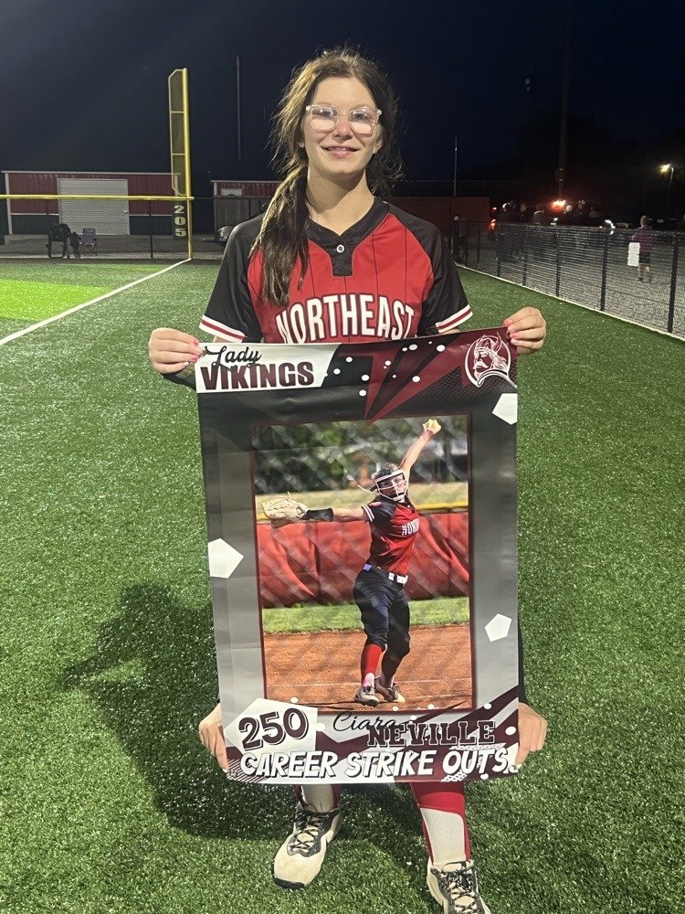 Softball player holds banner